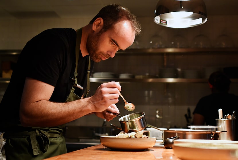 Executive chef Toby Archibald prepares steamed clams with watercress