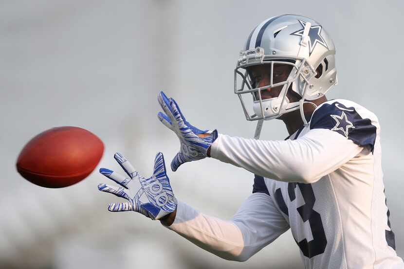 Cowboys wide receiver Michael Gallup (13) works on catching the ball in a drill during...
