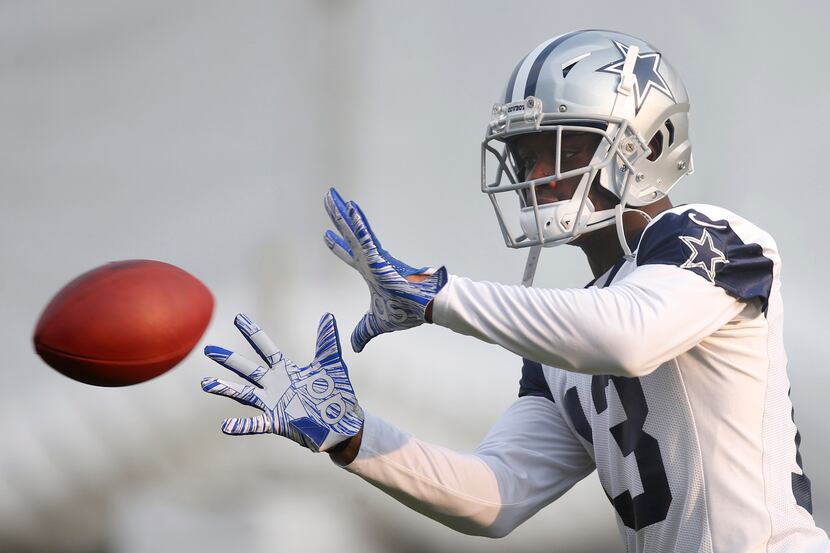 Cowboys wide receiver Michael Gallup (13) works on catching the ball in a drill during...