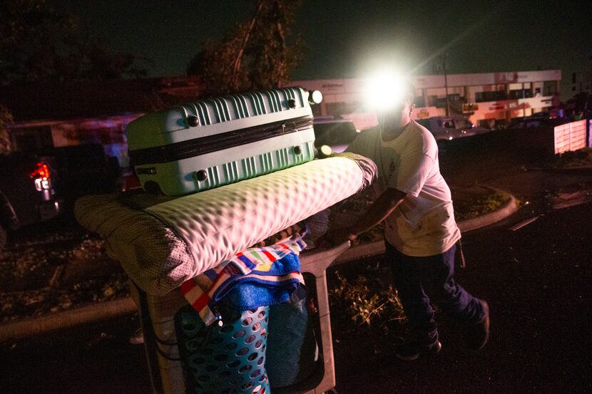 Antonio González moves items from his home on Glenrio Lane, which sustained significant...