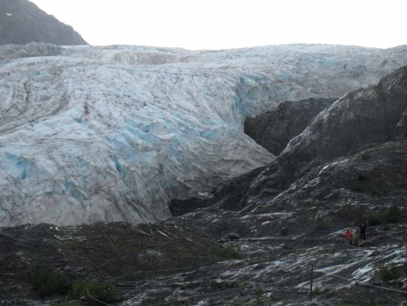 This photo taken Aug. 4, 2012, shows tourists walking to Exit Glacier in Kenai Fjords...