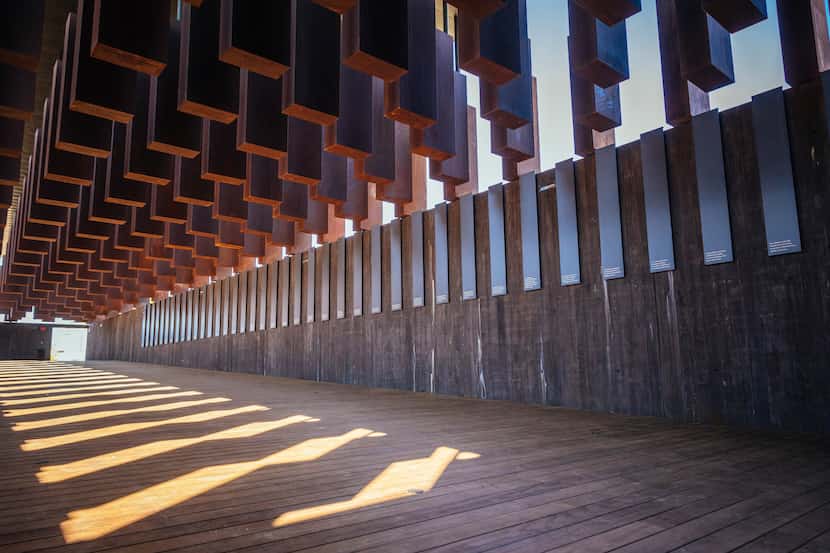 Eight hundred weathered steel columns, each one etched with the names of a lynching victim,...