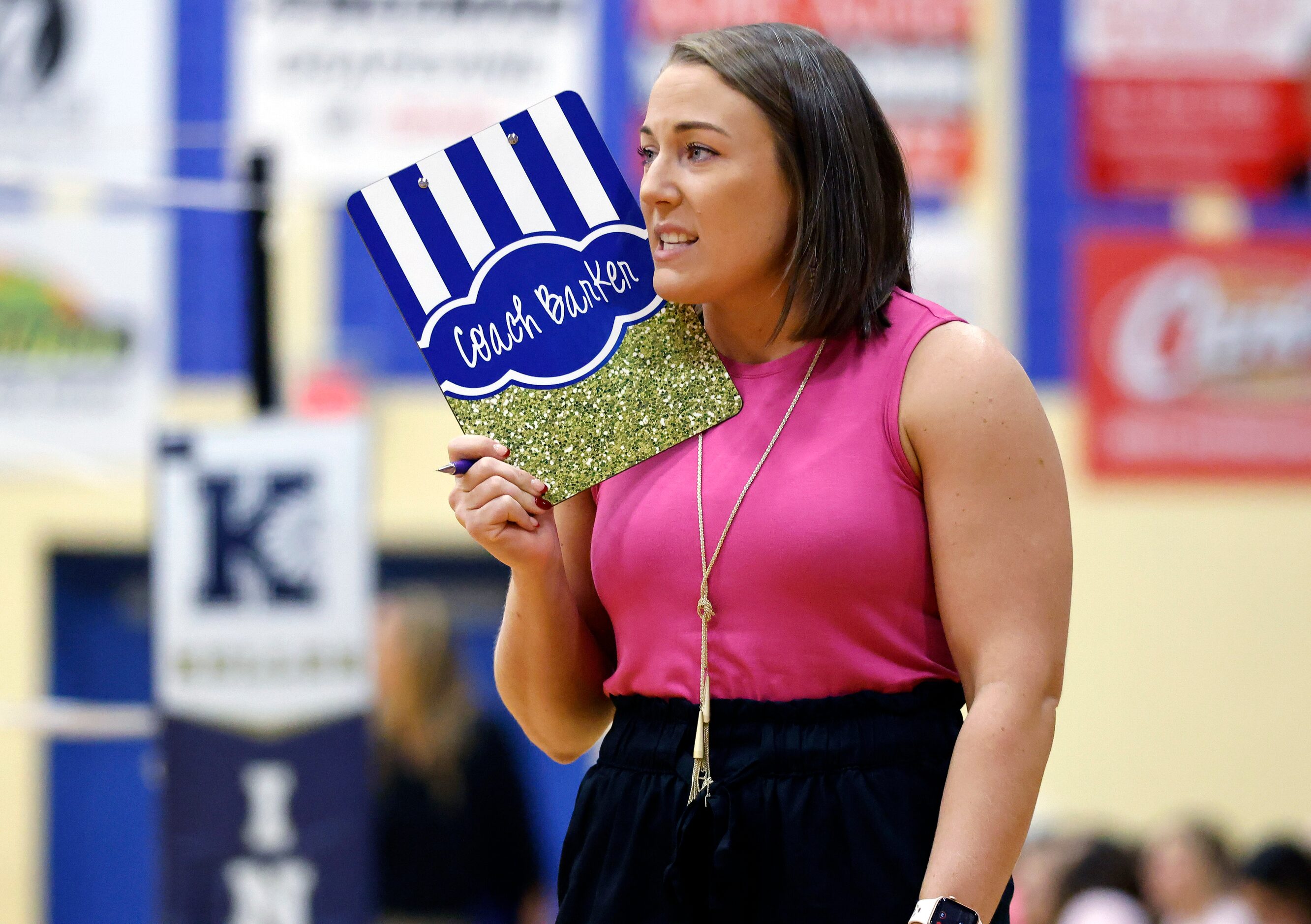 Keller High head coach Danielle Barker delivers instruction to her hitter during their...