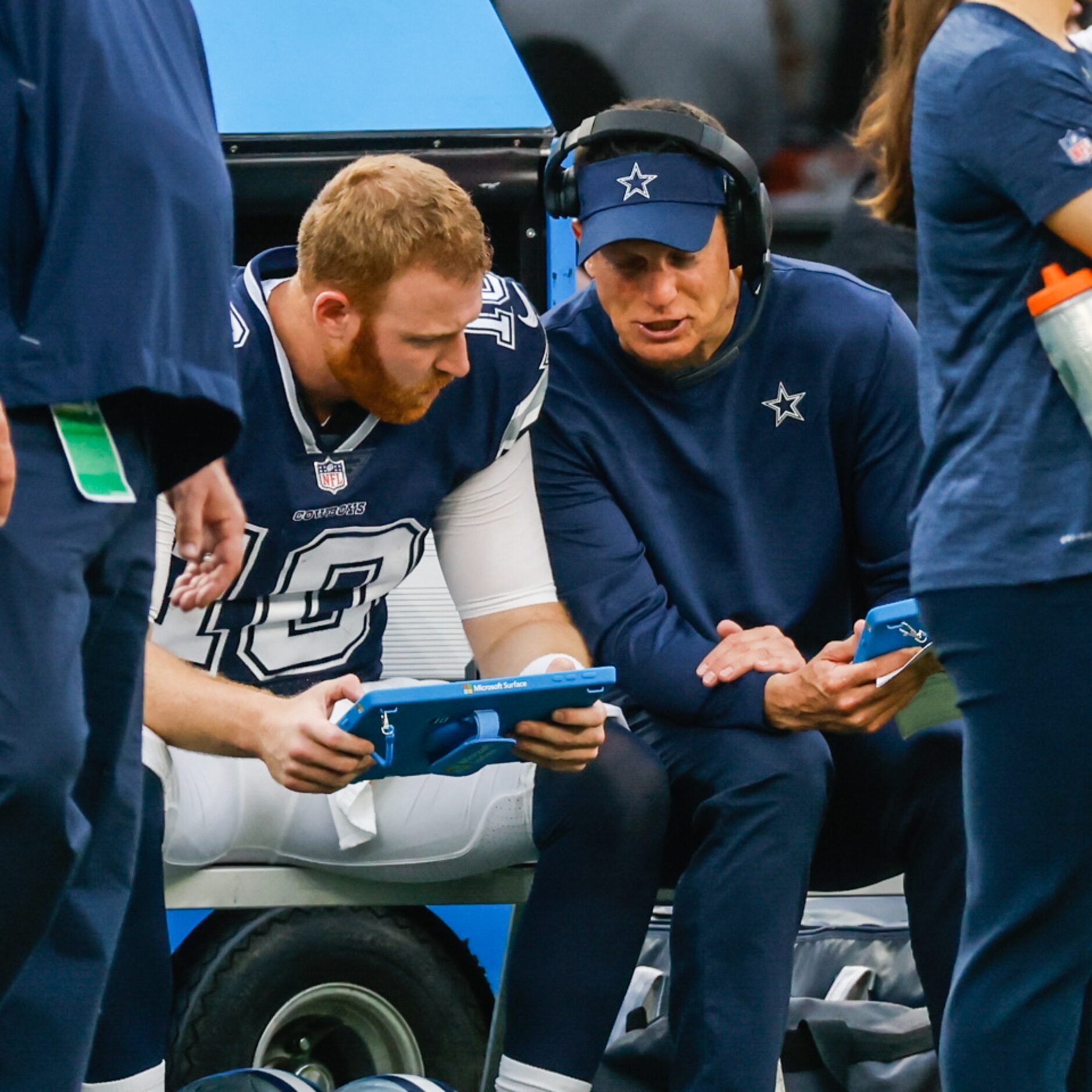 Dallas Cowboys quarterback Cooper Rush (10) talks with offensive line coach Joe Philbin...