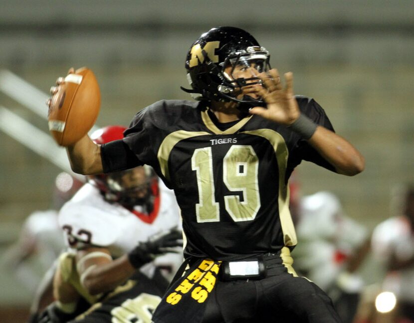 Mansfield quarterback Jerod Evans (19) passes downfield during second quarter action of...