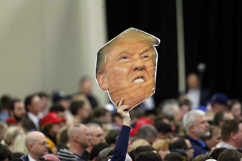 
A supporter holds a cut of Republican presidential hopeful Donald Trump at a rally during...