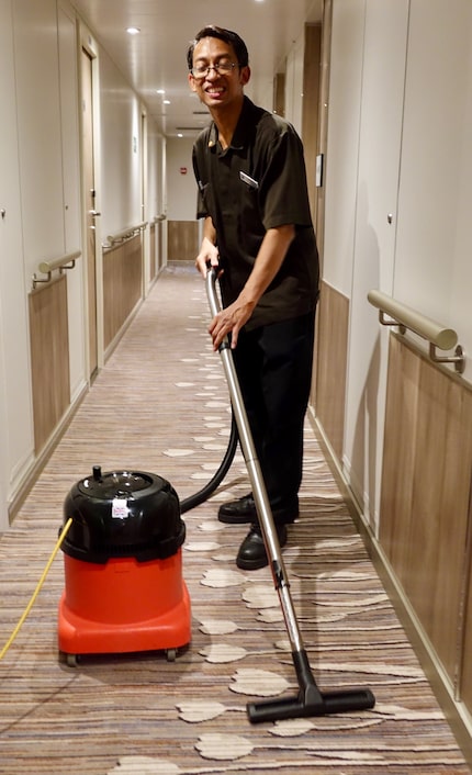 Cabin steward Budhi Prasetyo vacuums the hallway daily after he and his partner have made up...