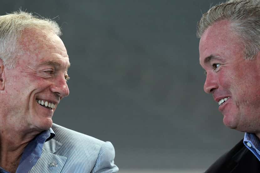 Jerry Jones and his son Stephen Jones talk during a press conference in 2011.