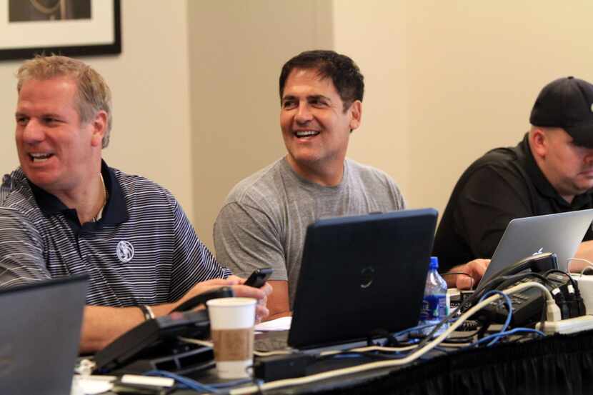 Dallas Mavericks owner Mark Cuban, center, with Tony Ronzone, left, director of player...