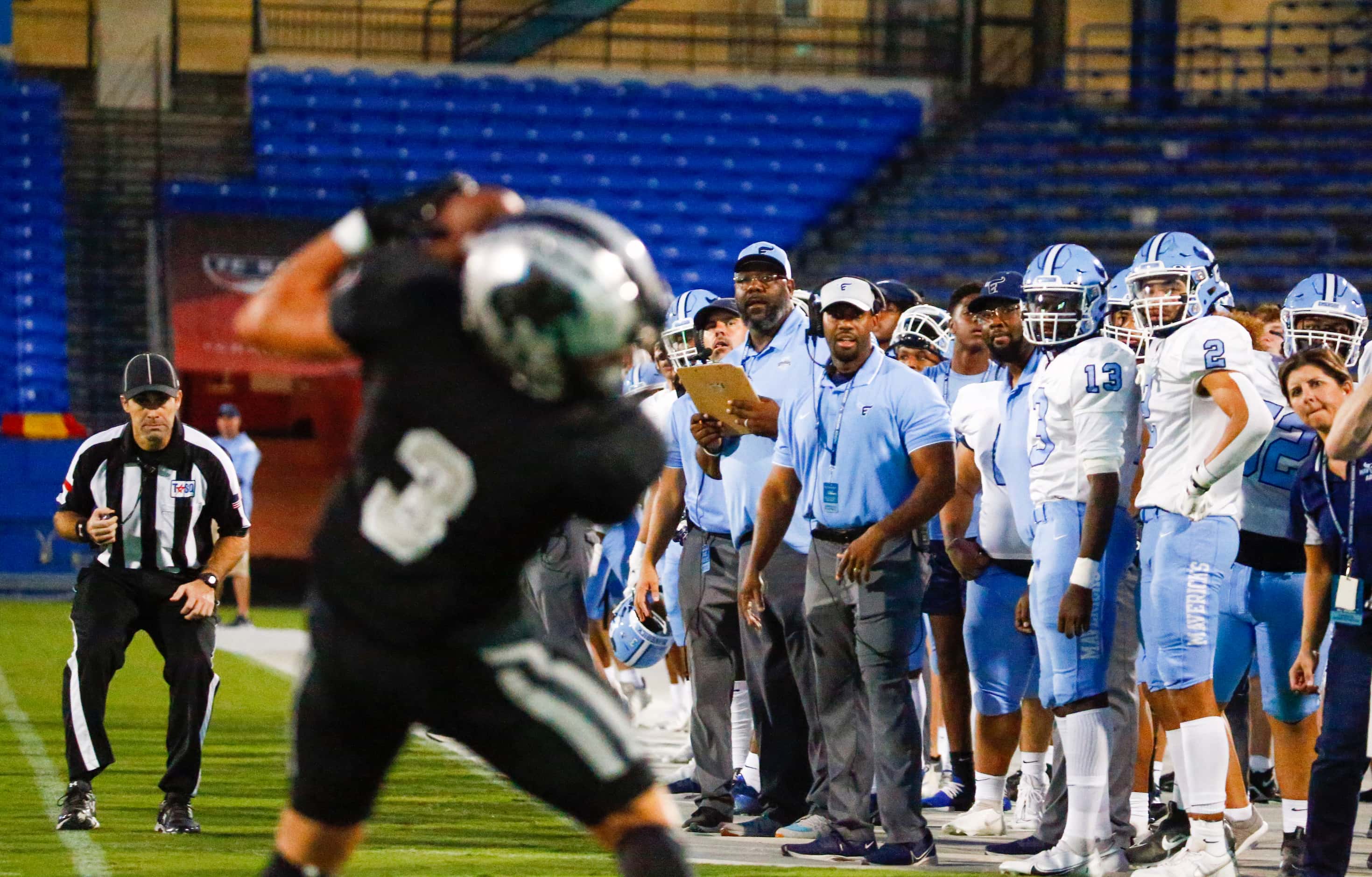 Emerson Mavericks players and staff watch as Panther Creek Panthers wide receiver Seth...
