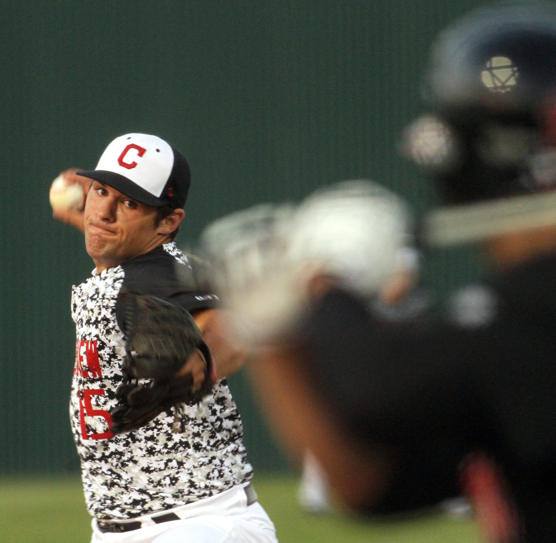 Carrollton Creekview pitcher Brandon White (15) delivers a fastball to a Dallas Hillcrest...