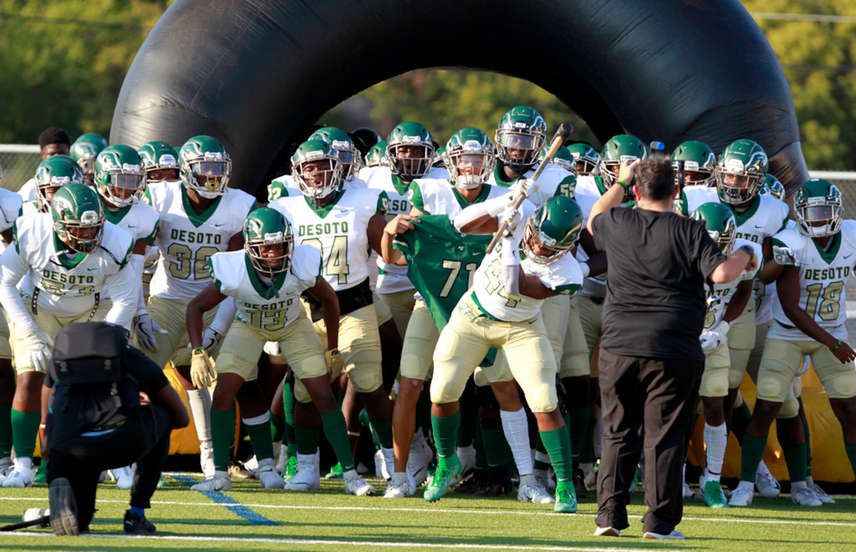 Desoto's DeMarcus Jackson (44) beats the turf with a sledge hammer, just prior to the team...