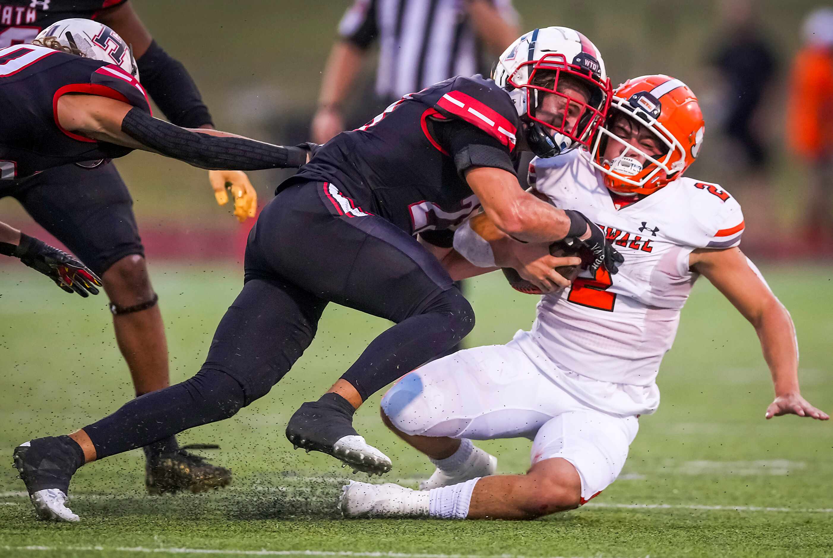 Rockwall running back  Zach Hernandez (2) is brought down by Rockwall-Heath linebacker Noah...