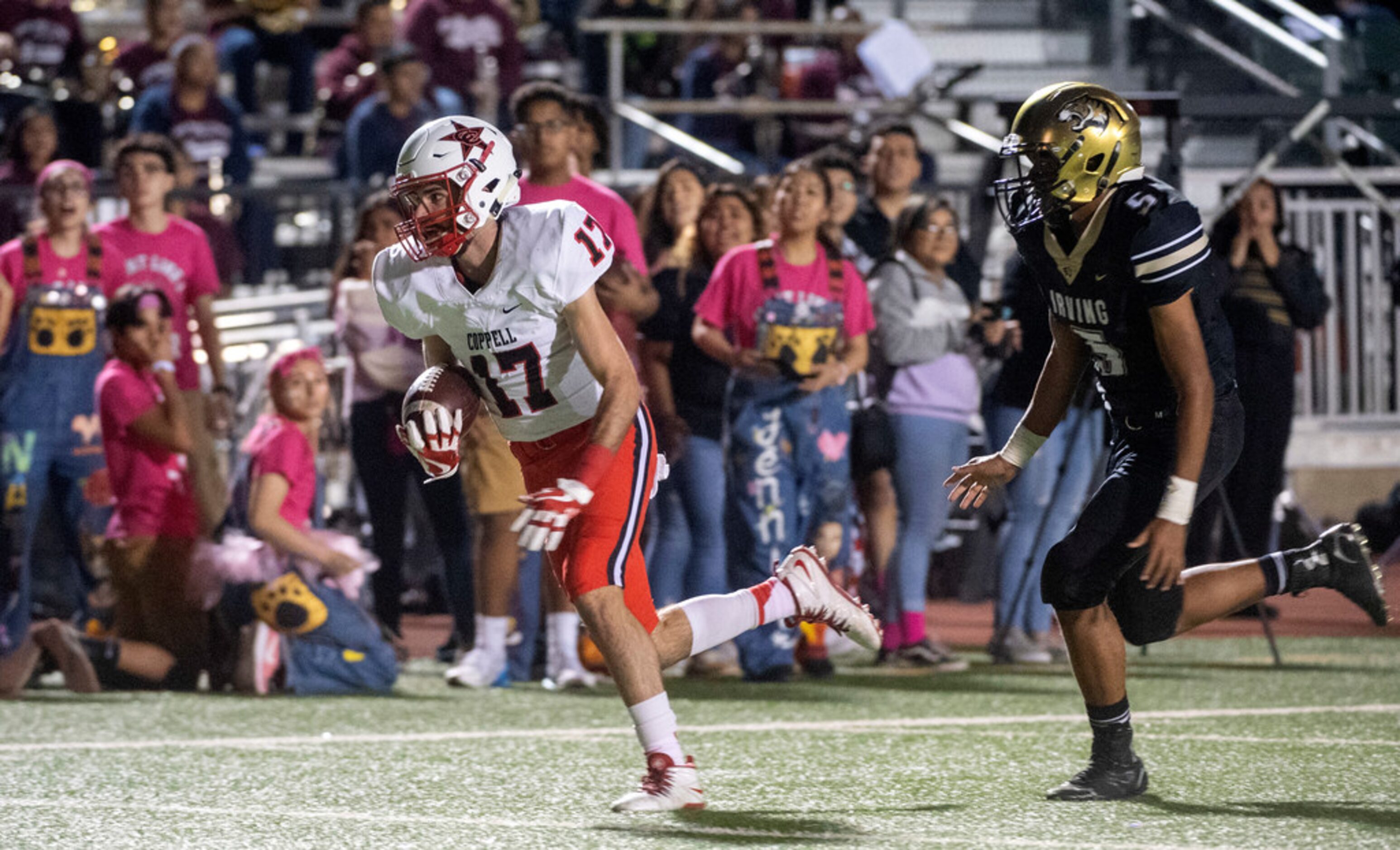 Coppell senior wide receiver Josh Bartolacci (17) runs away from Irving sophomore linebacker...