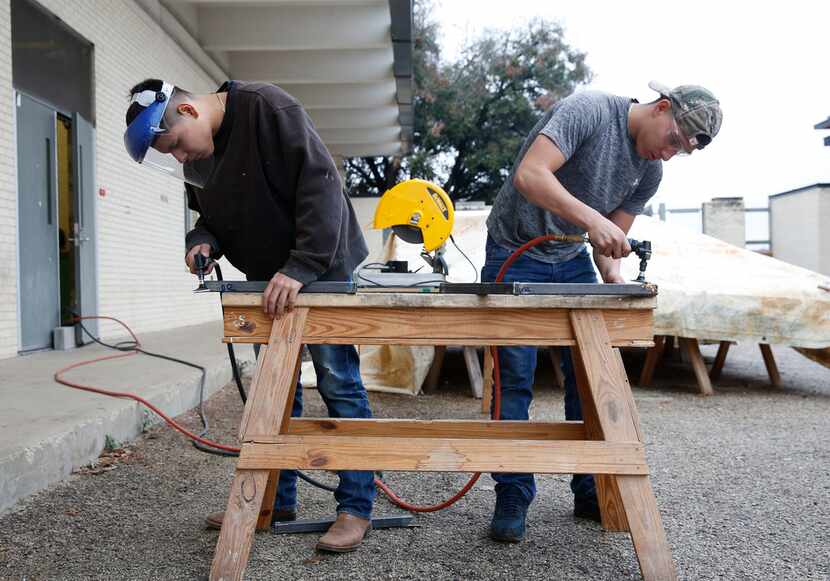 Sophomore Diego Reyes (left) and junior Alvaro Luna Jr. grind their welds during shop class...