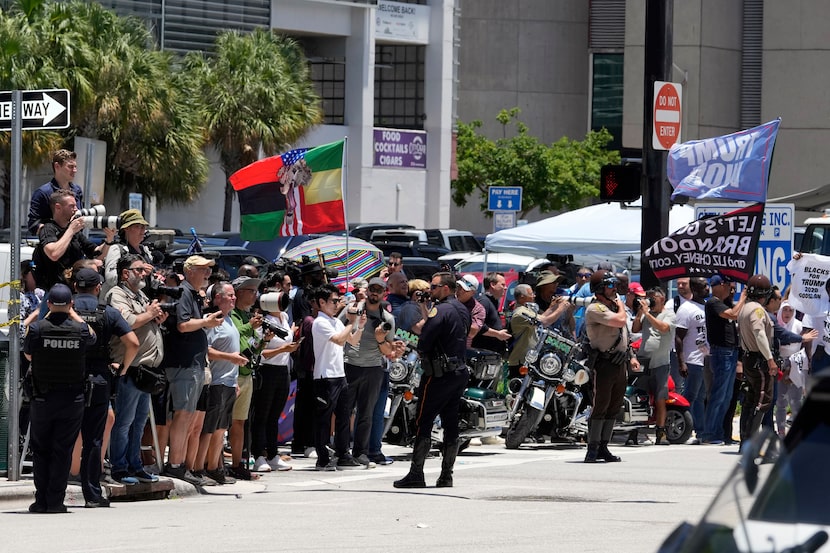 People watch as they motorcade carrying former President Donald Trump arrives at the Miami...