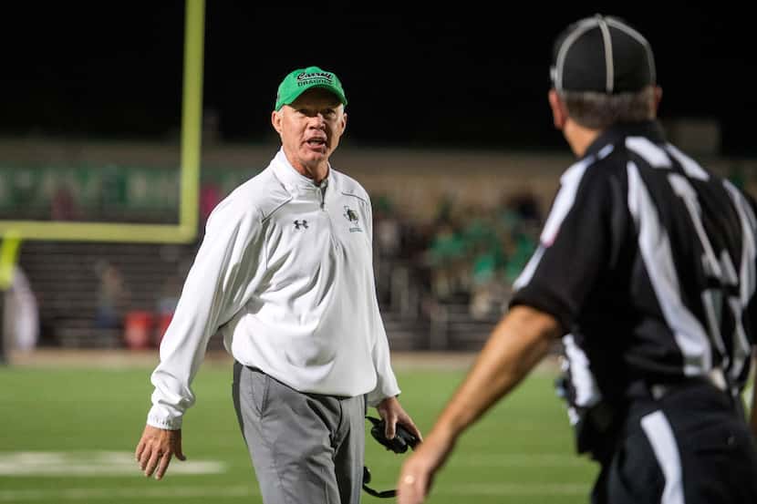 Southlake Carroll head coach Hal Wasson expresses his displeasure to a referee in the first...