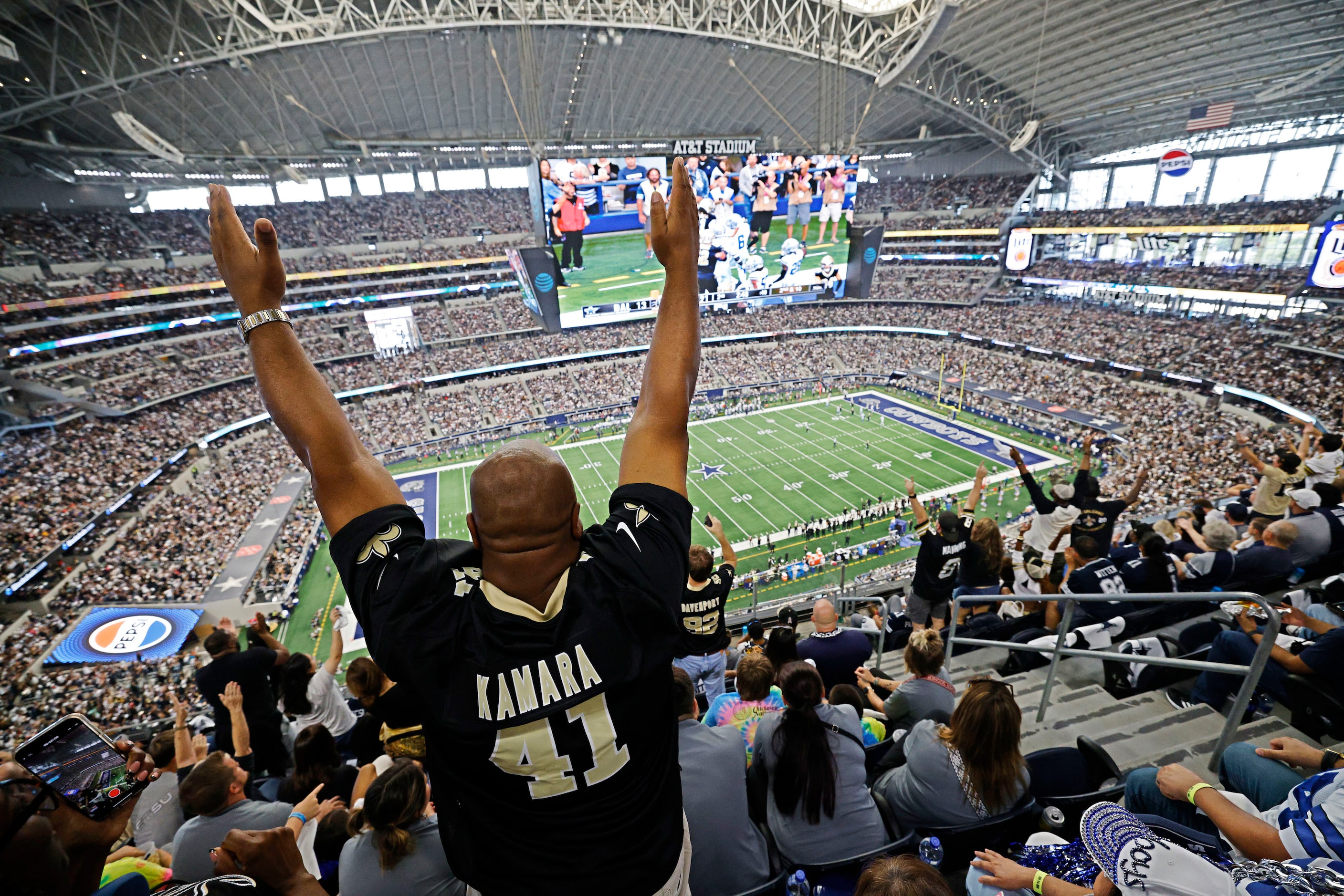 New Orleans Saints fans celebrate after their team scored a touchdown during the first half...