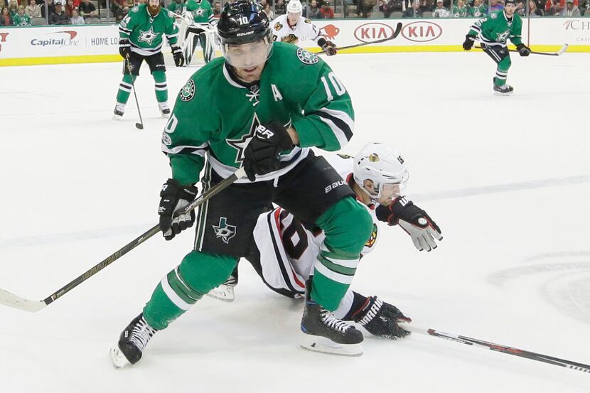 Stars left wing Patrick Sharp (10) takes control of the puck in front of Chicago Blackhawks...