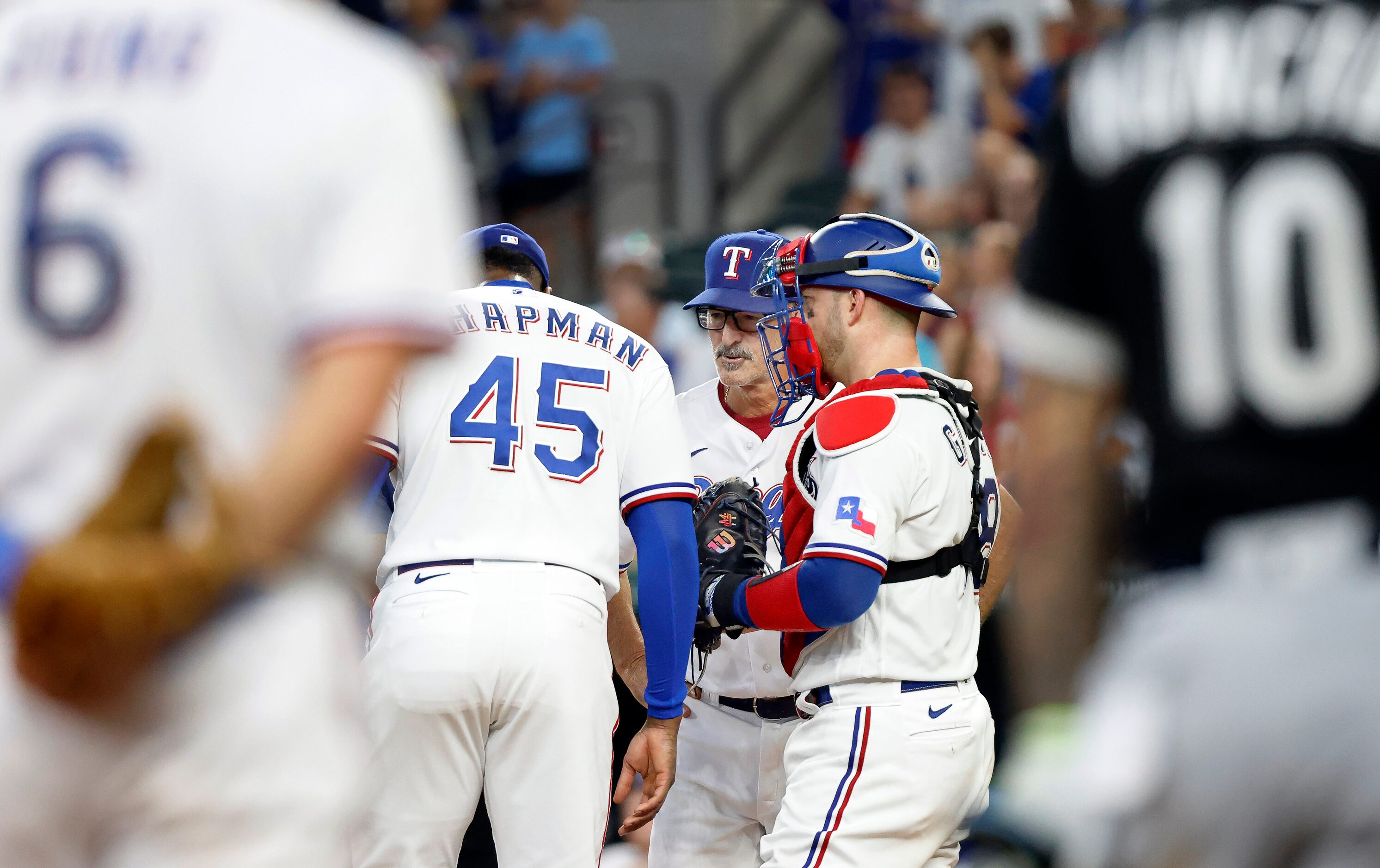 Texas Rangers relief pitcher Aroldis Chapman (45) receives a visit to the mound from...