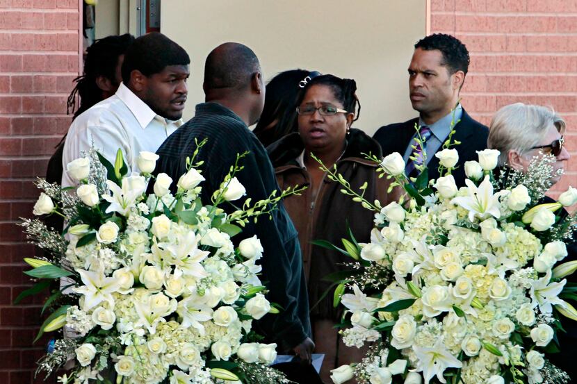 Cowboys player Josh Brent (far left) leaves Oak Cliff Bible Fellowship with others,...