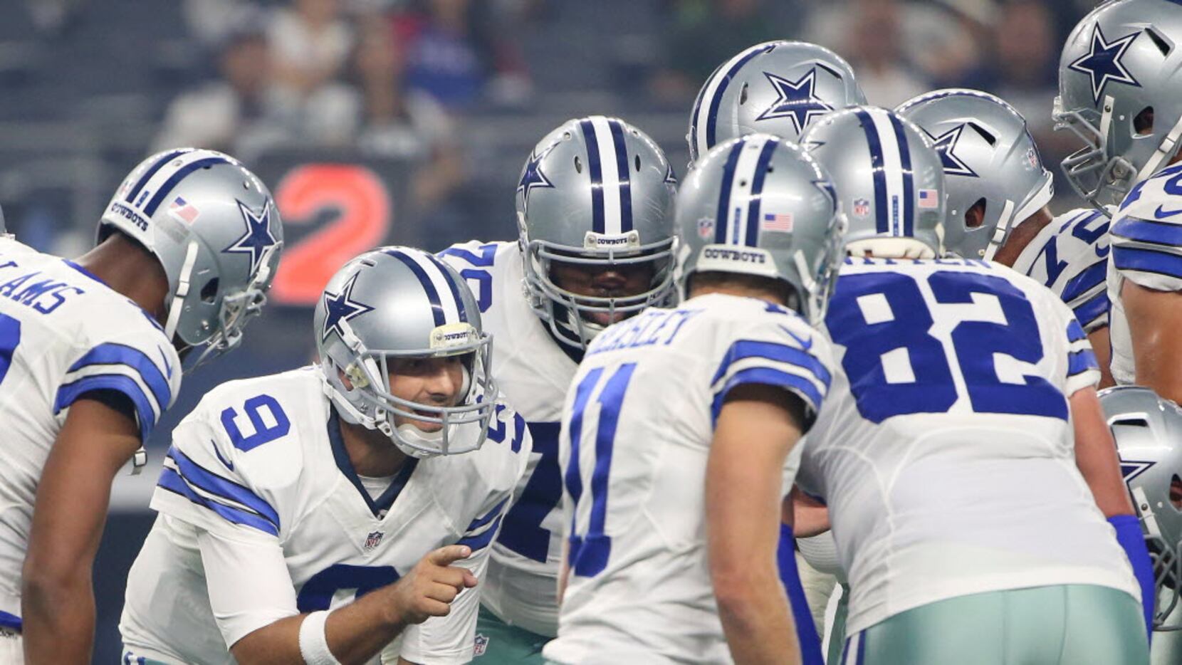 Dallas Cowboys quarterback Tony Romo (9) speaks in the huddle in the first quarter during a...