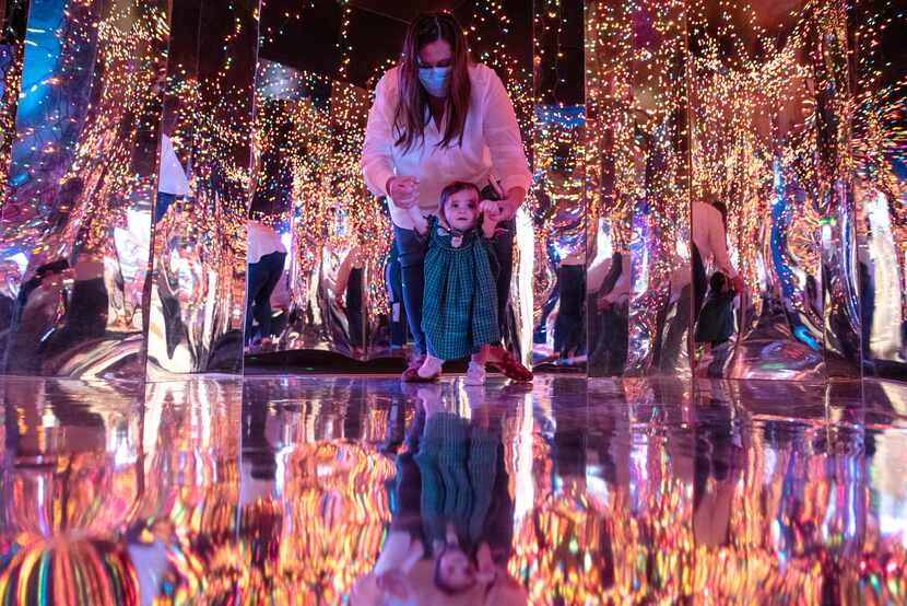 Allie Turney and daughter Nina walked in a reflective room lit with Christmas lights inside...