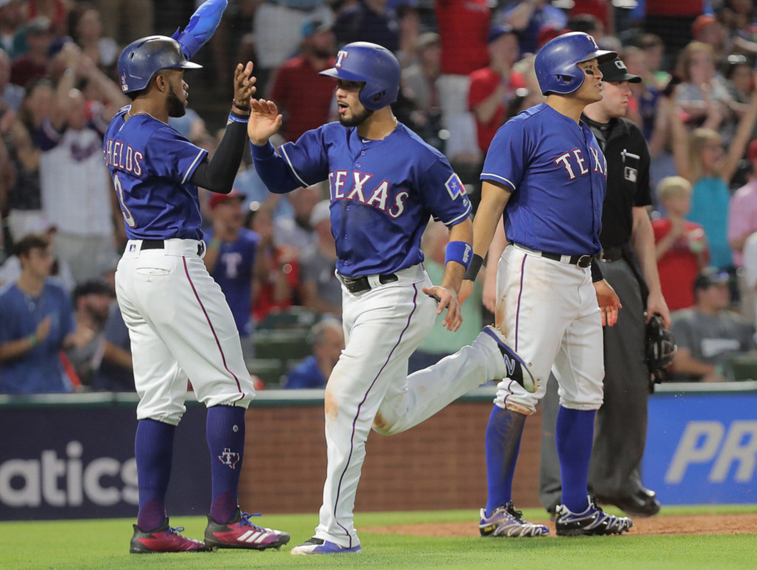 Texas Rangers center fielder Delino DeShields (3), third baseman Isiah Kiner-Falefa (9) and...