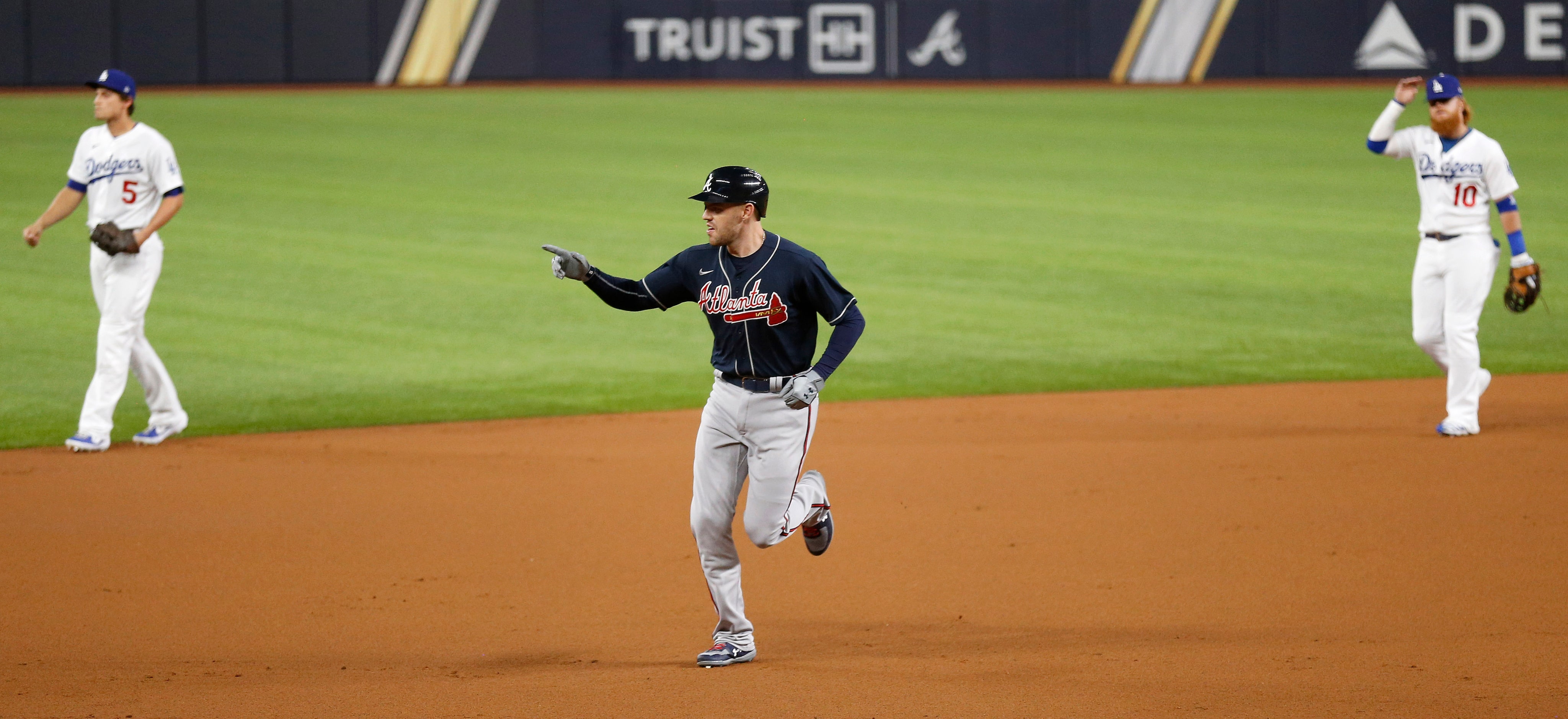 Atlanta Braves first baseman Freddie Freeman (5) rounds the bases after hitting a solo home...