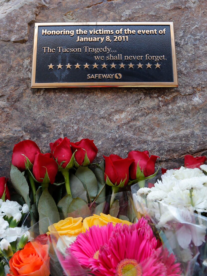 Flowers are lined up on the third anniversary at the site of the Tucson shootings,...