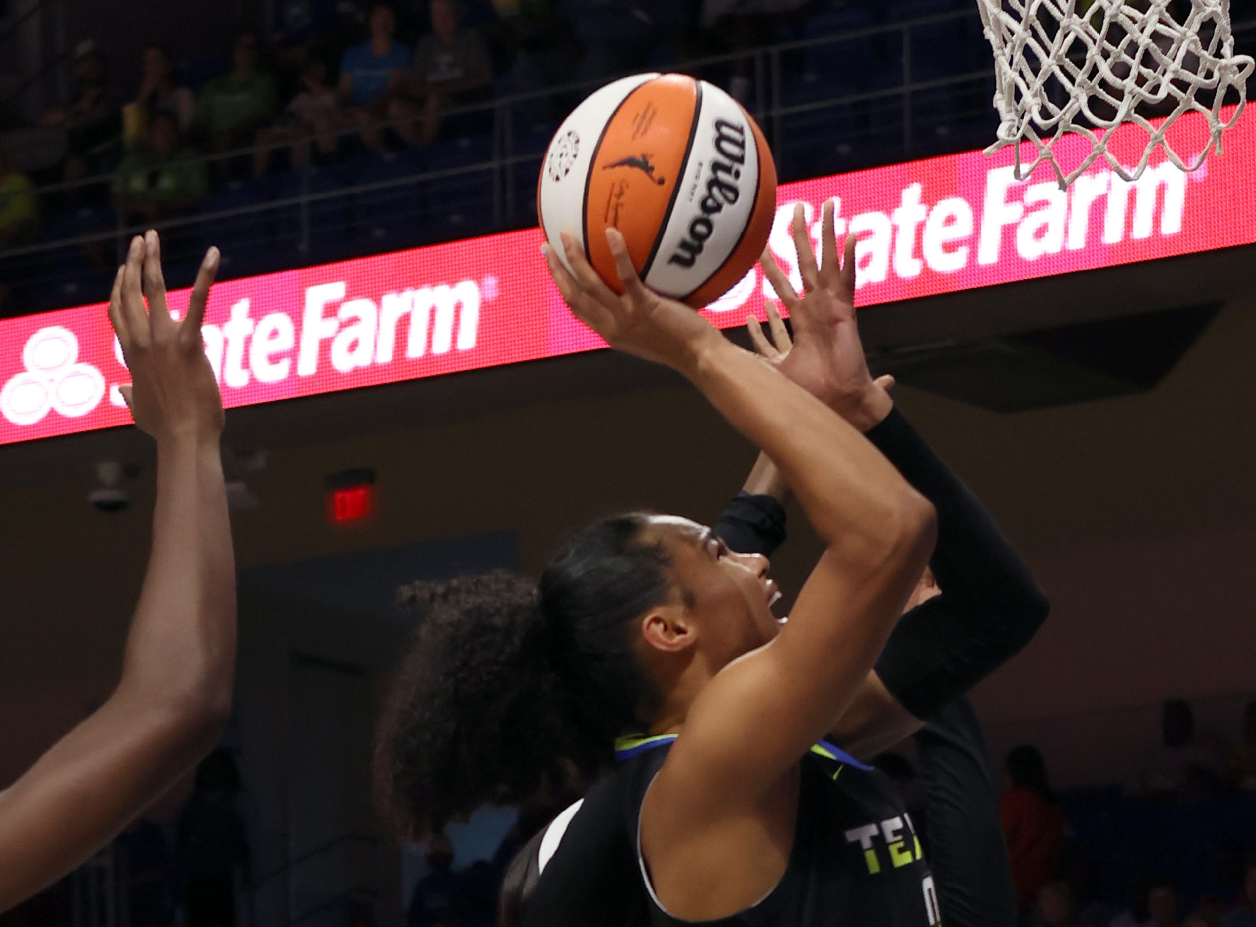 Dallas Wings forward Satou Sabally (0) drives to the basket against a pair of Chicago Sky...