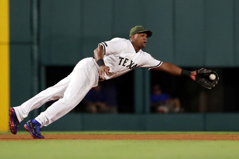 Texas Rangers third baseman Adrian Beltre (29) makes a diving catch on a ball hit by Tampa...