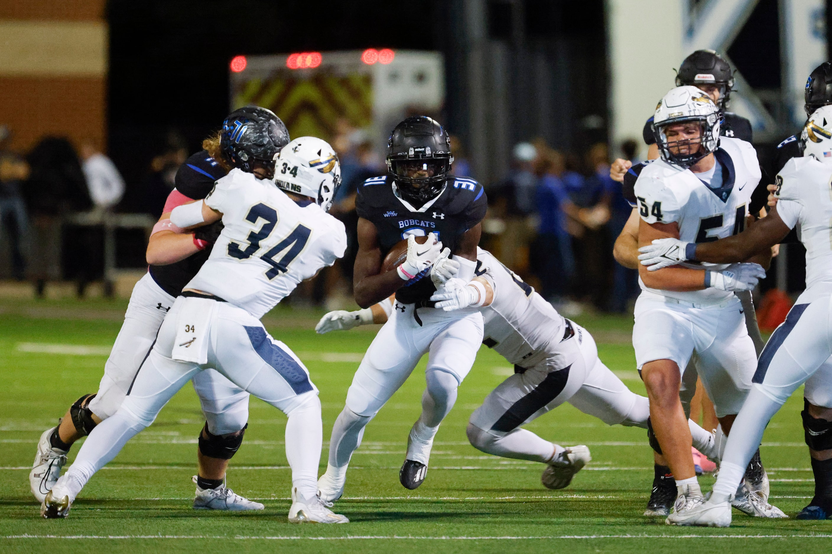 Byron Nelson’s Manny Mulumba (31) runs with the ball during the first half of a football...