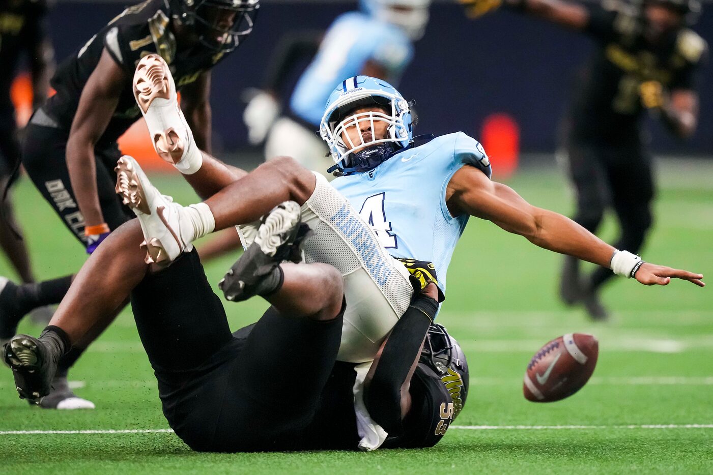 Frisco Emerson quarterback Michael Hawkins (4) loses a fumble as he is sacked by South Oak...