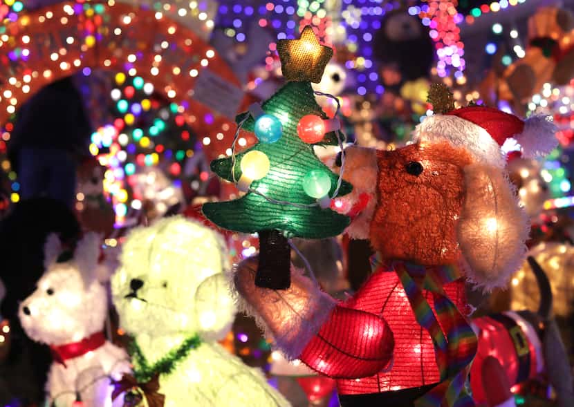 The Burkman family's holiday lights display hosts a menagerie of more than 200 plushy mesh...