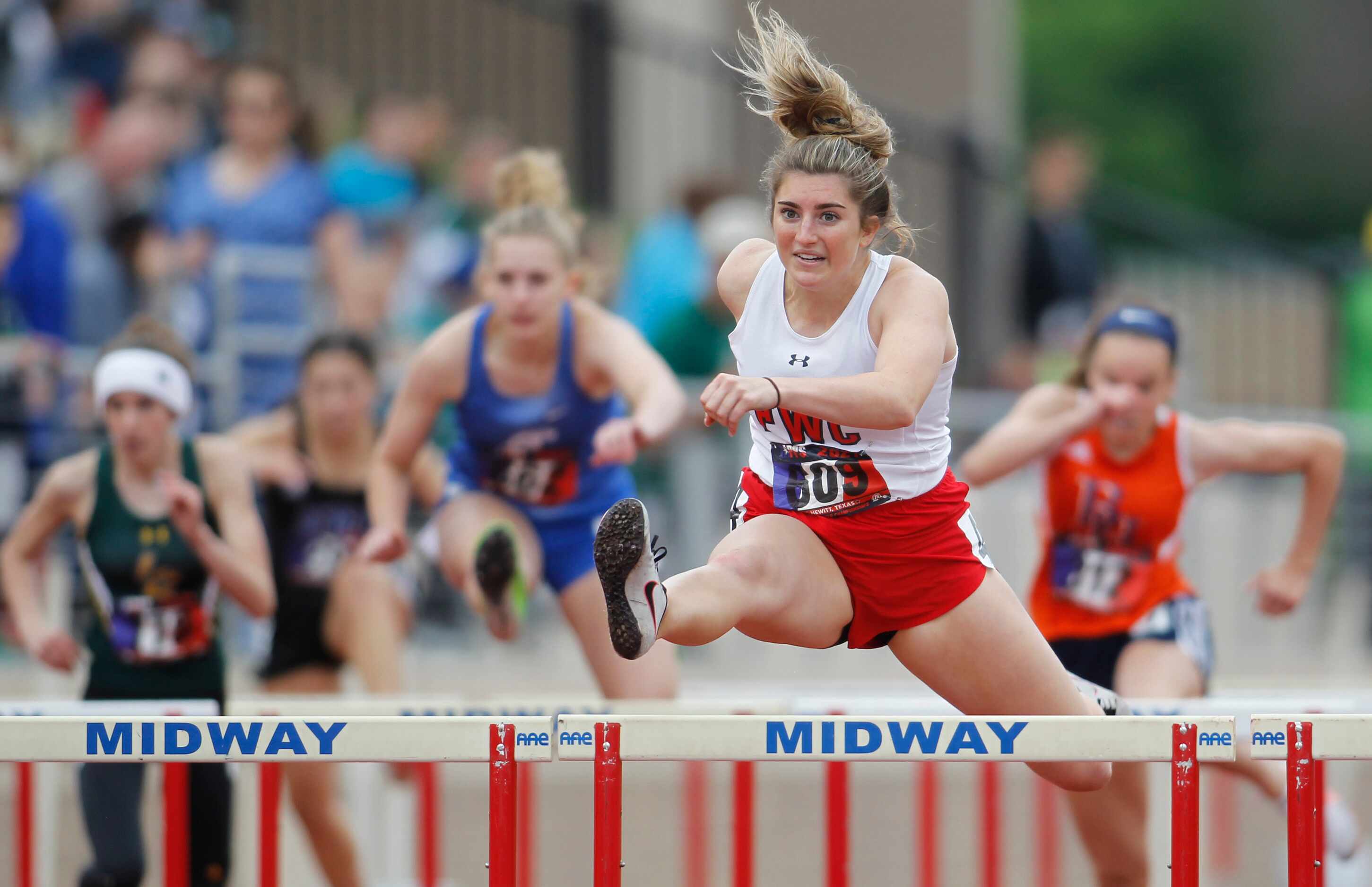 Fort Worth Christian's Abby Klipstein clears a hurdle enroute to her 1st place finish in the...