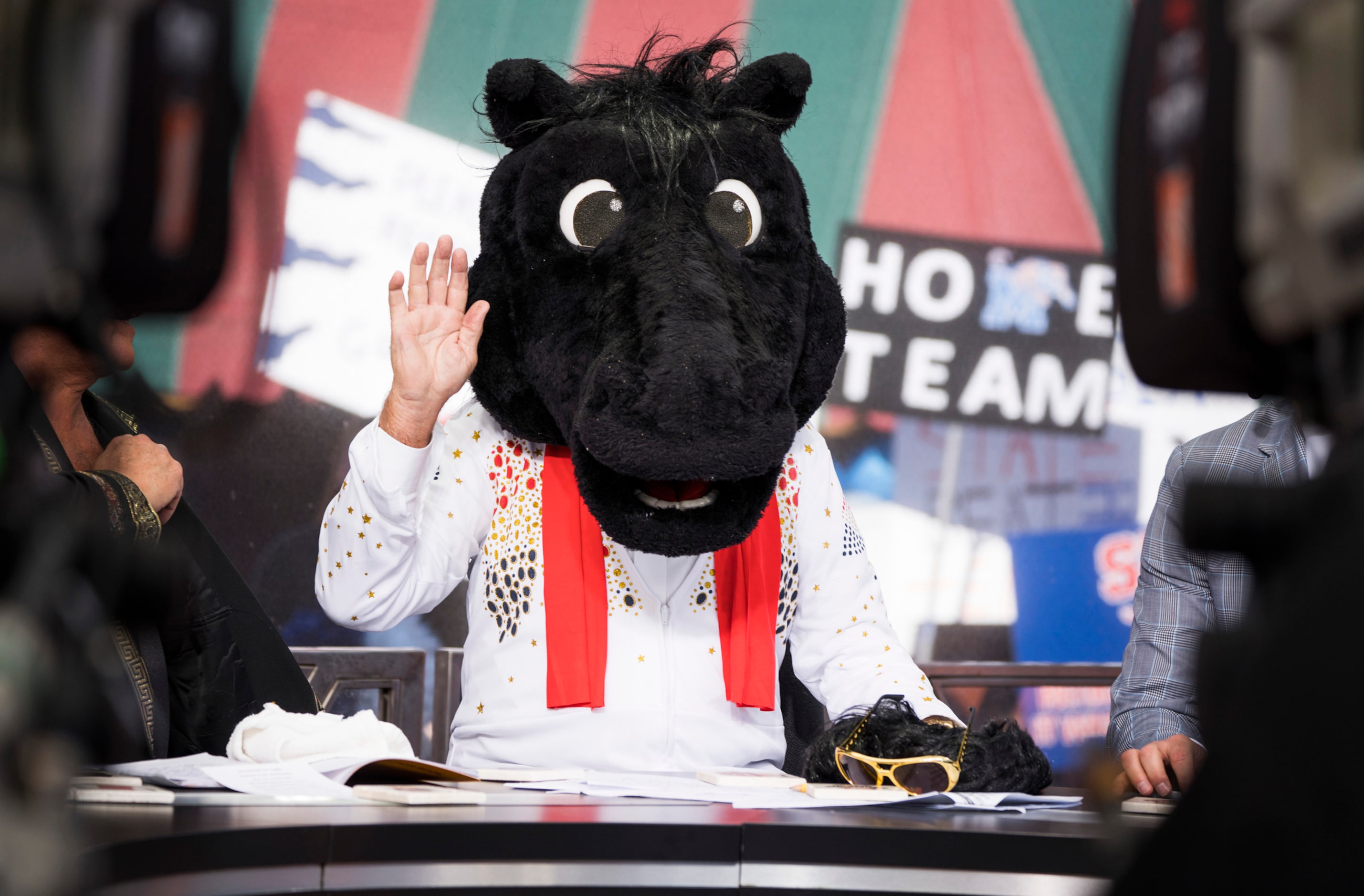 Lee Cosro waves wearing the headgear of SMU mascot Peruna after he picked the Mustangs for...