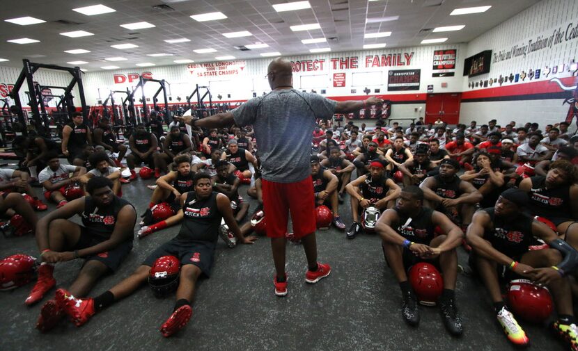 New Cedar Hill football coach Carlos Lynn shares a motivational message before his team hit...