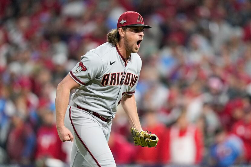Arizona Diamondbacks relief pitcher Kevin Ginkel celebrates after the last out in the ninth...
