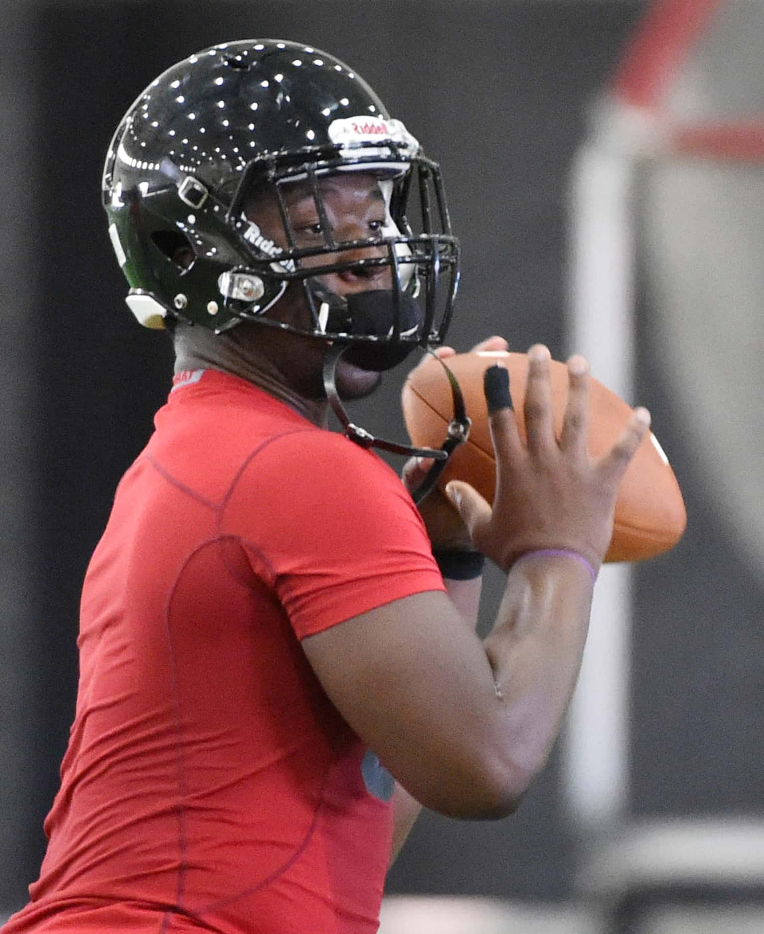 Quarterback Tyler Natee runs a play during Euless Trinity's first day of football practice...