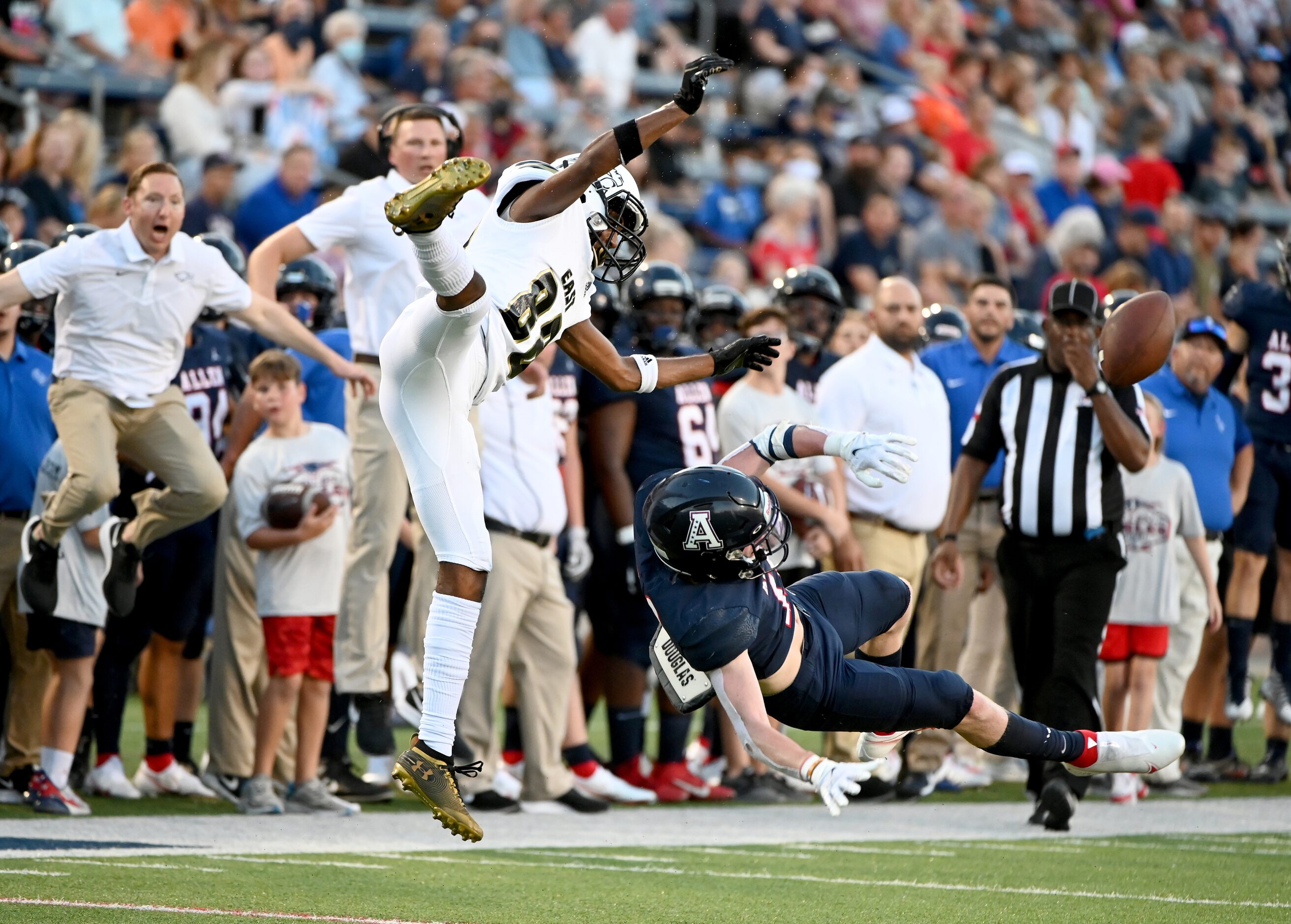 Allen’s Caison Smith, in blue, breaks up a pass intended for Plano East’s Rushil Patel...