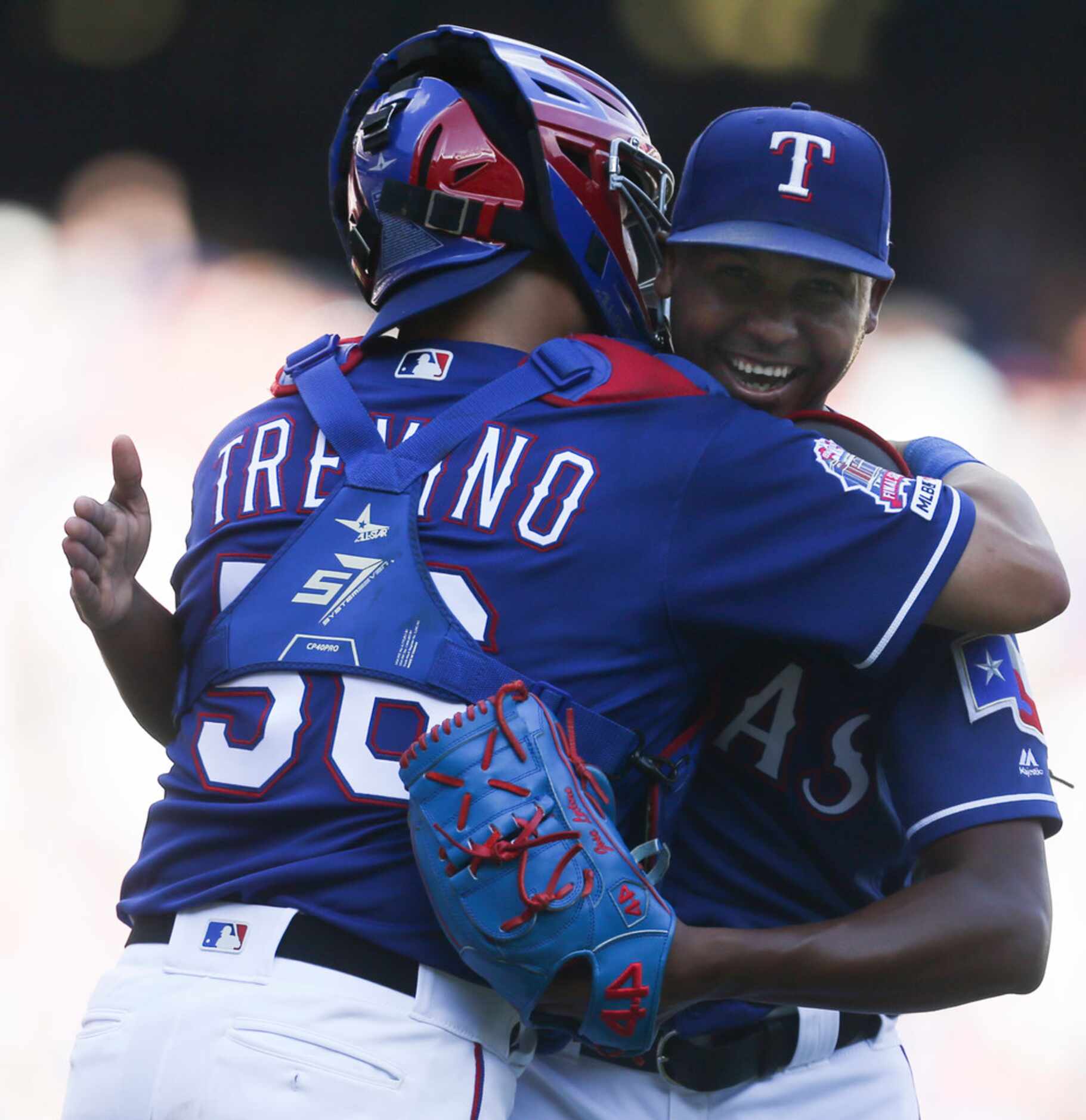 Texas Rangers catcher Jose Trevino (56) embraces relief pitcher Jose Leclerc (25) following...