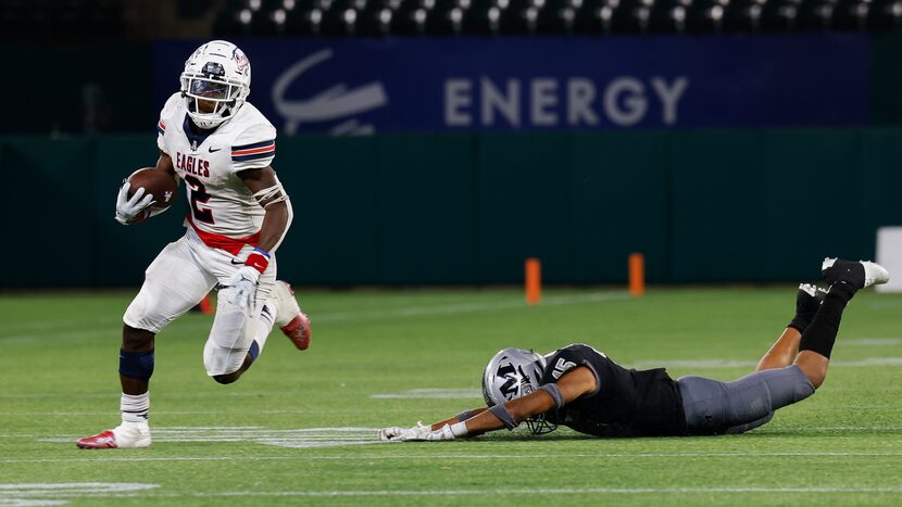 Allen’s running back Kayvion Sibley evades Arlington Martin’s defensive back Cadence Hall...