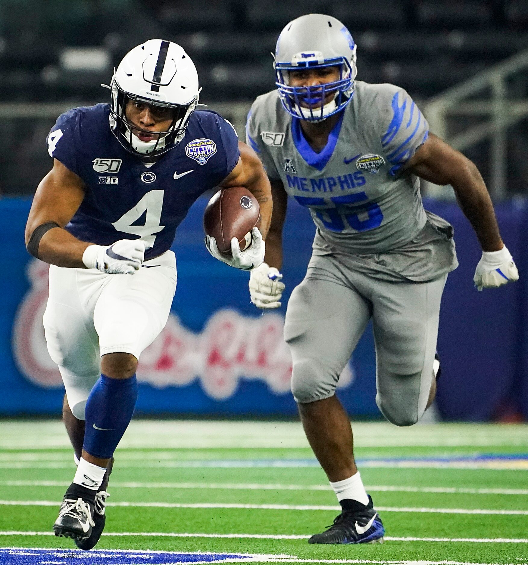 Penn State running back Journey Brown (4) races past Memphis defensive end Bryce Huff (55)...