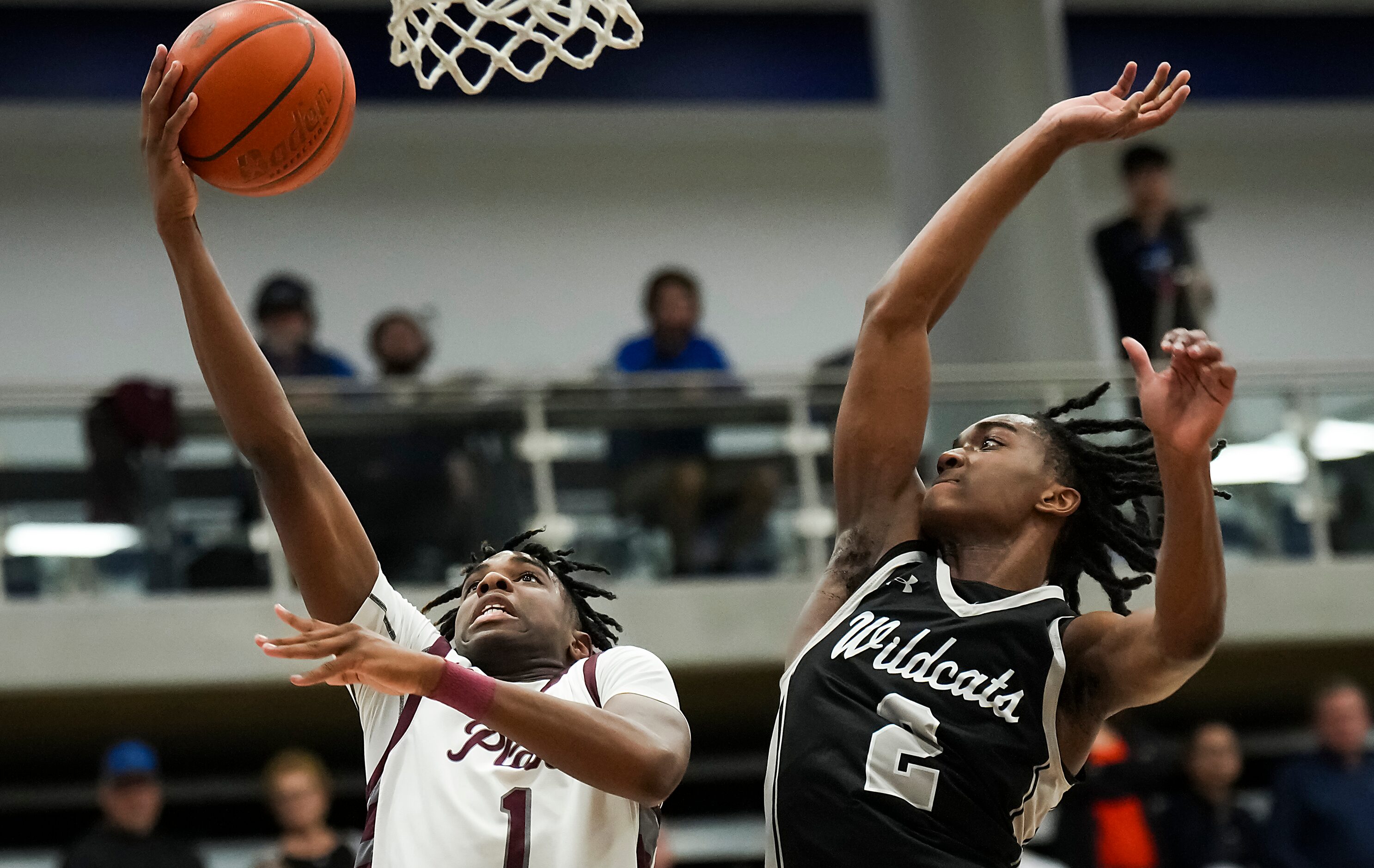 Plano guard Tyran Mason (1) scores past Denton Guyer’s Jeremiah Green (2) during the second...