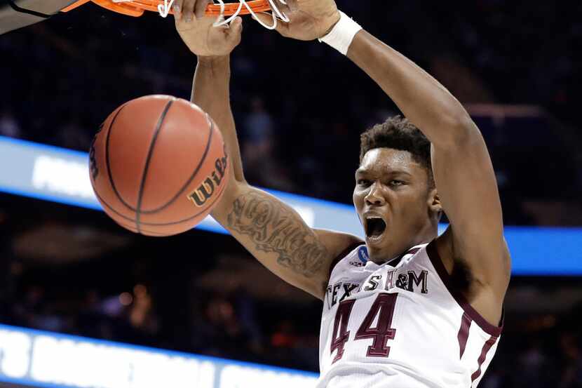 FILE - In this March 16, 2018, file photo, Texas A&M's Robert Williams dunks against...