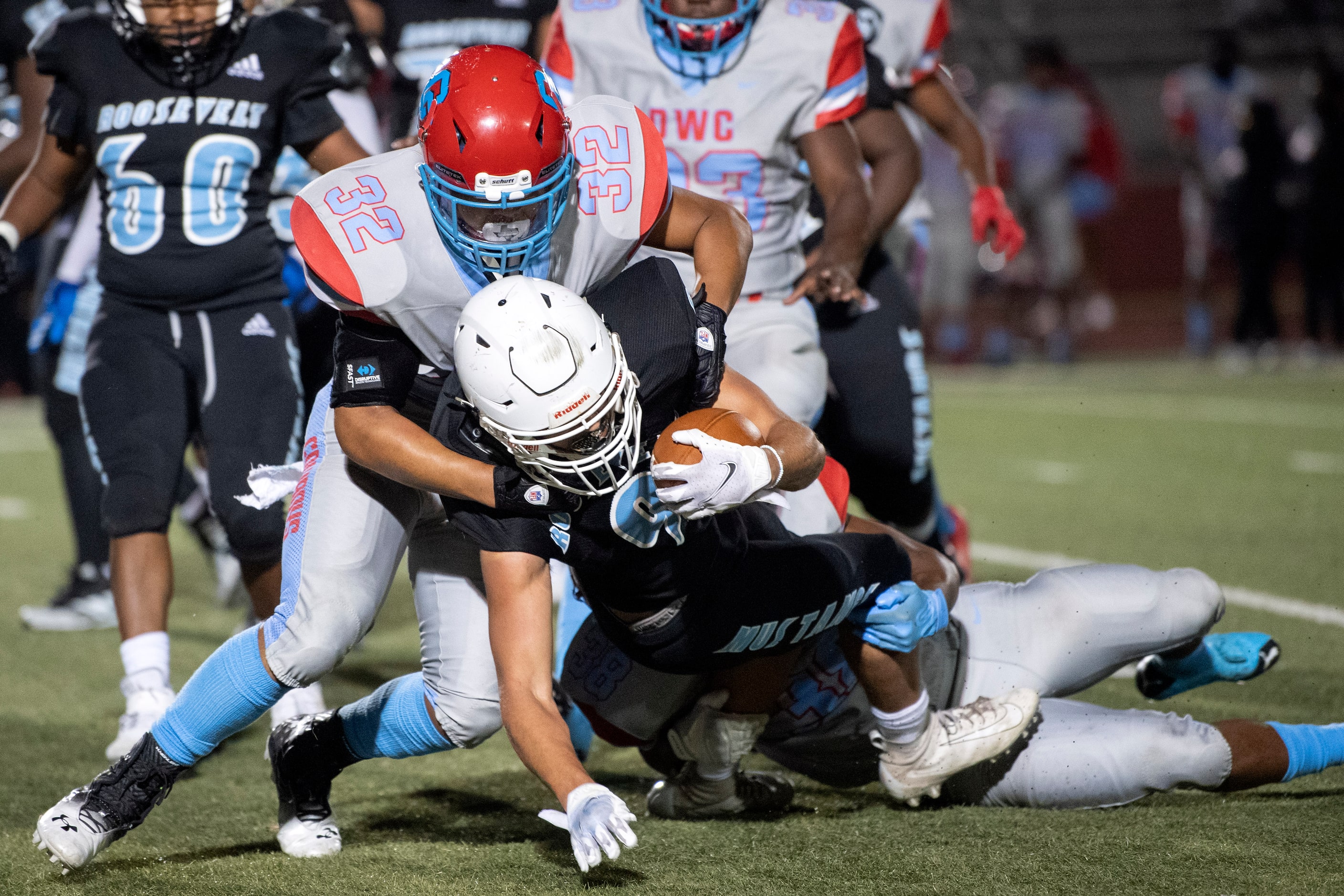 Carter senior linebacker Jacoby Carthan (32) stops Roosevelt senior running back Ethan Smith...