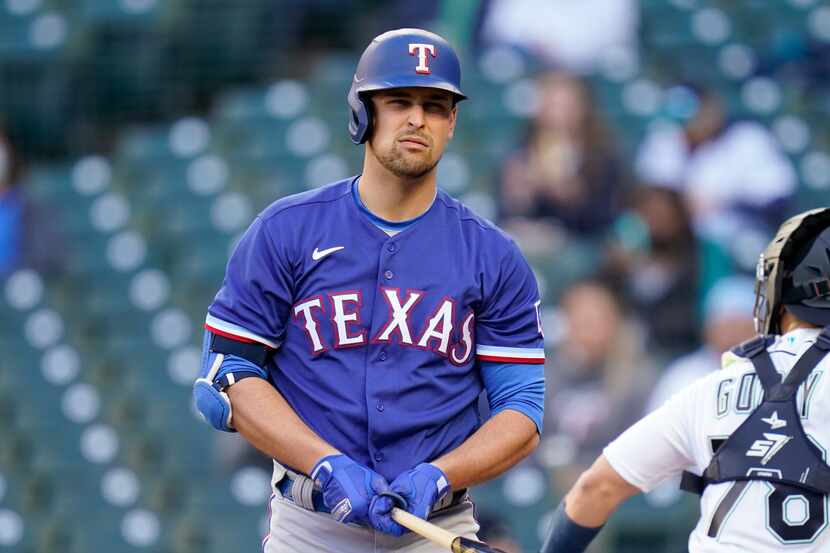 Texas Rangers' Nate Lowe turns toward his team's dugout after striking out swinging against...