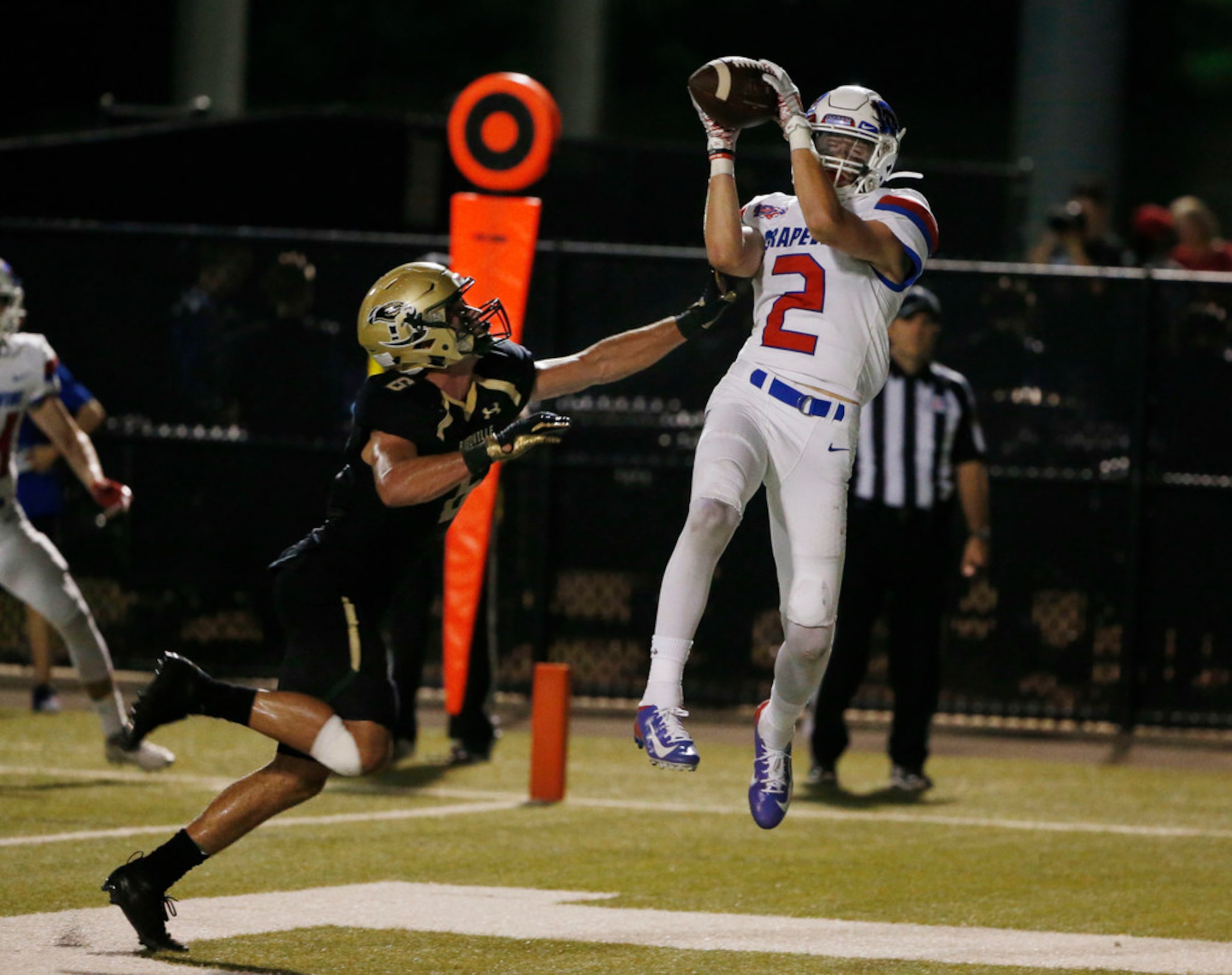 Grapevine's Jacob Edwards (2) scores a touchdown in front of Birdville defender Cade Shaffer...