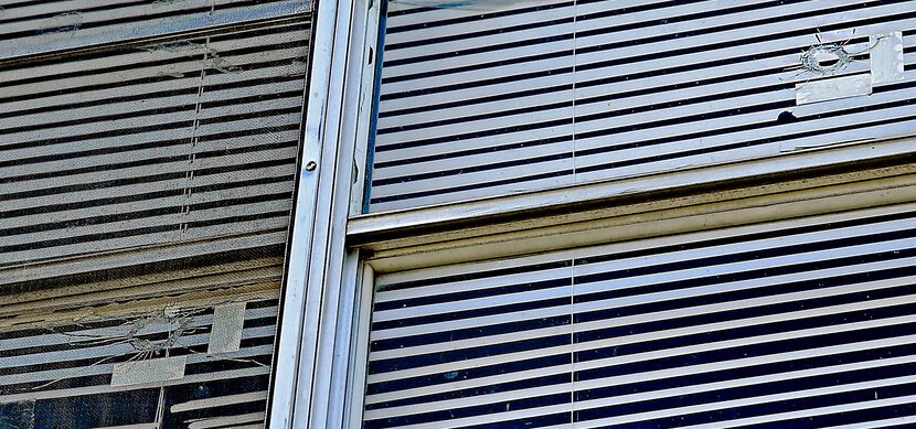 Bullet holes are left in the windows of the apartment where South Oak Cliff student NeQuacia...